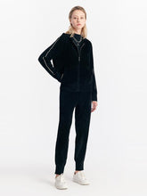 A lady is wearing a chic style sports suit.